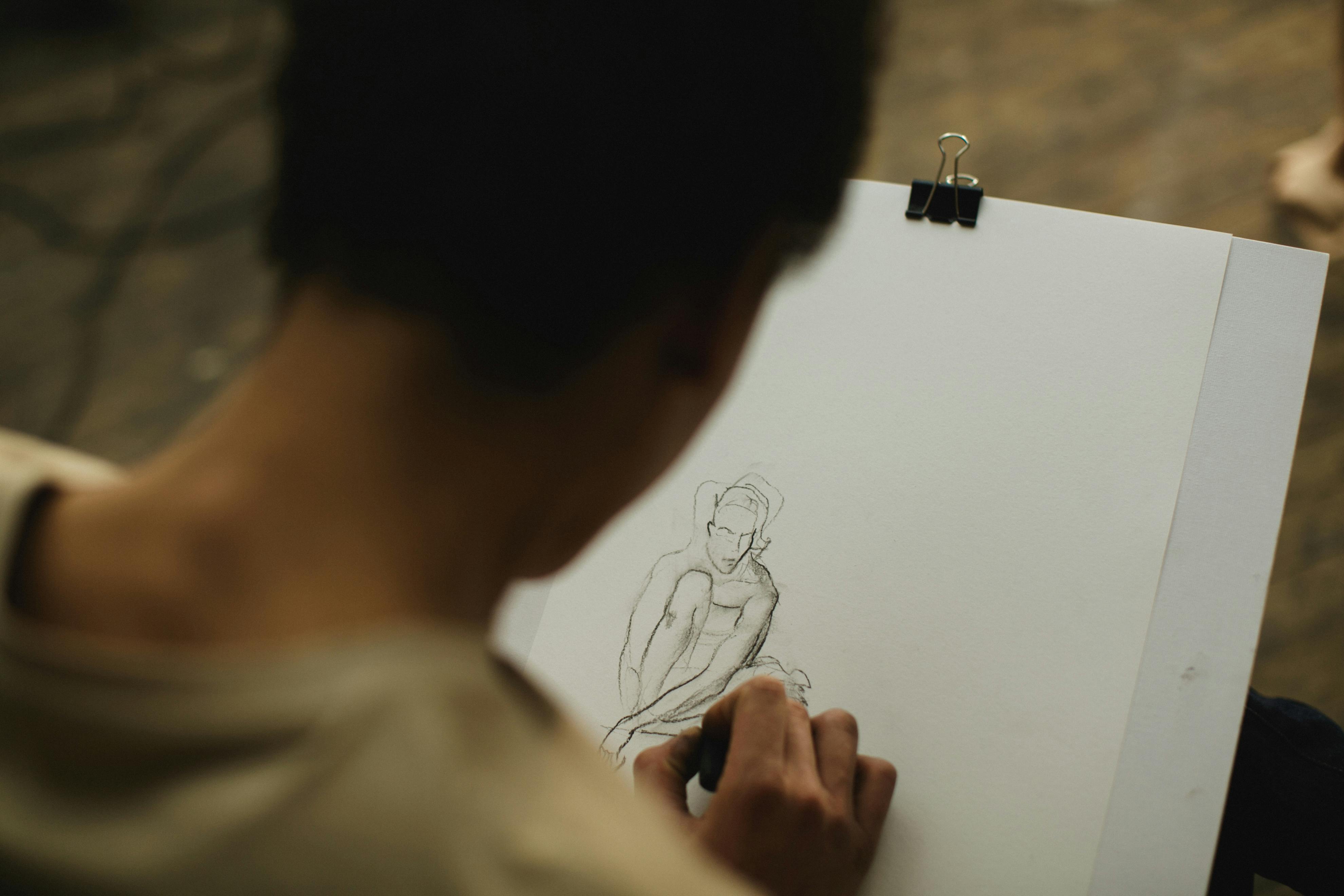 A hand sketches a drawing