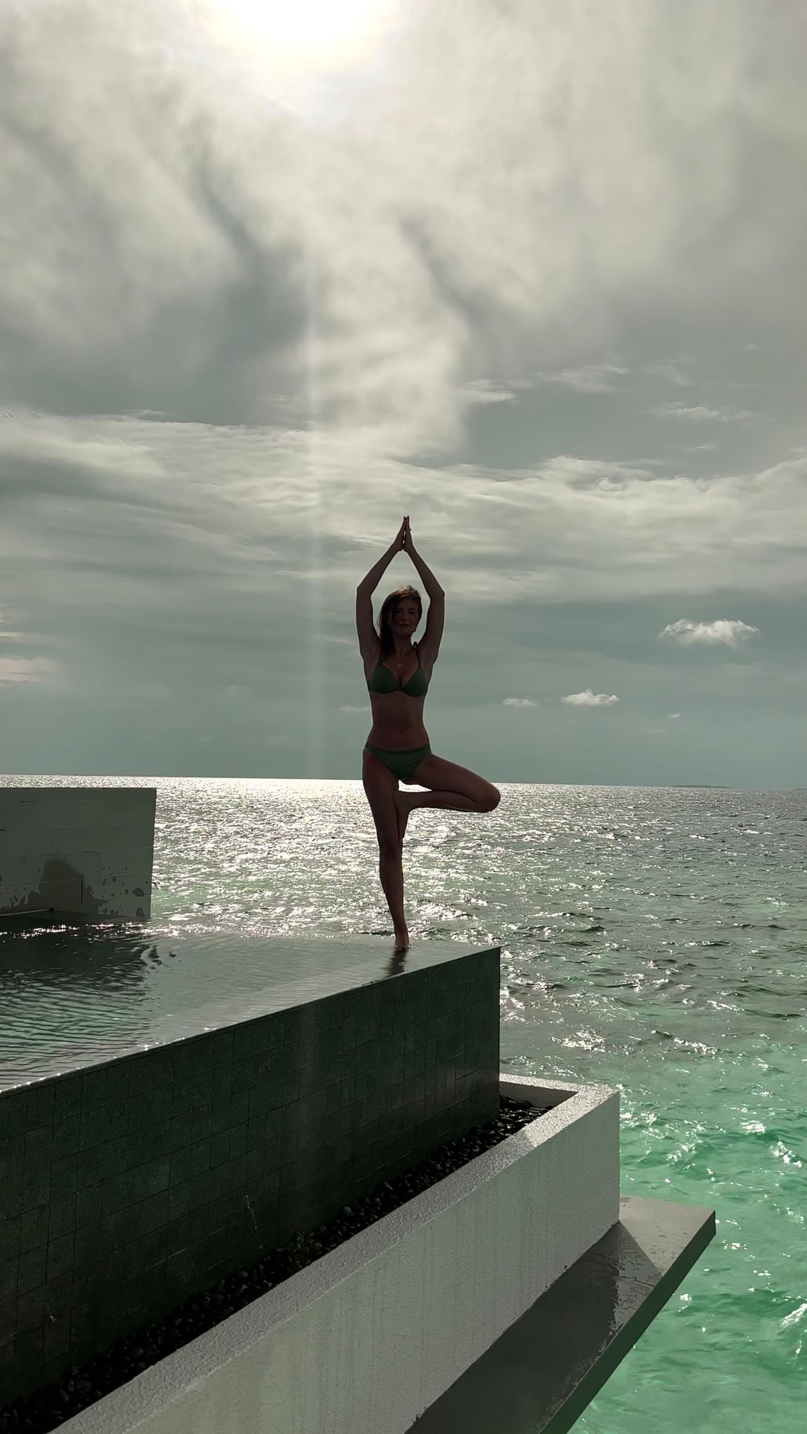 A woman balancing by the sea